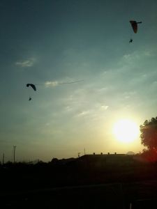 Para-gliders catching the sunset||Photo Credit: Rob Clarita